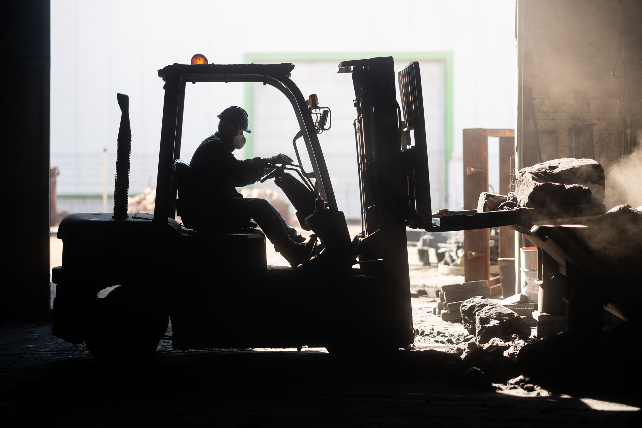 Shadow silhouette of forklift operator